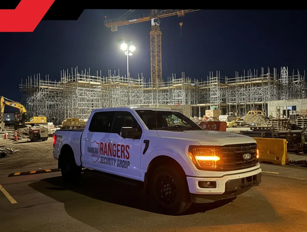 Mobile patrol security guard in uniform, using a wireless device to communicate with the team and  providing proactive on-site mobile security services.