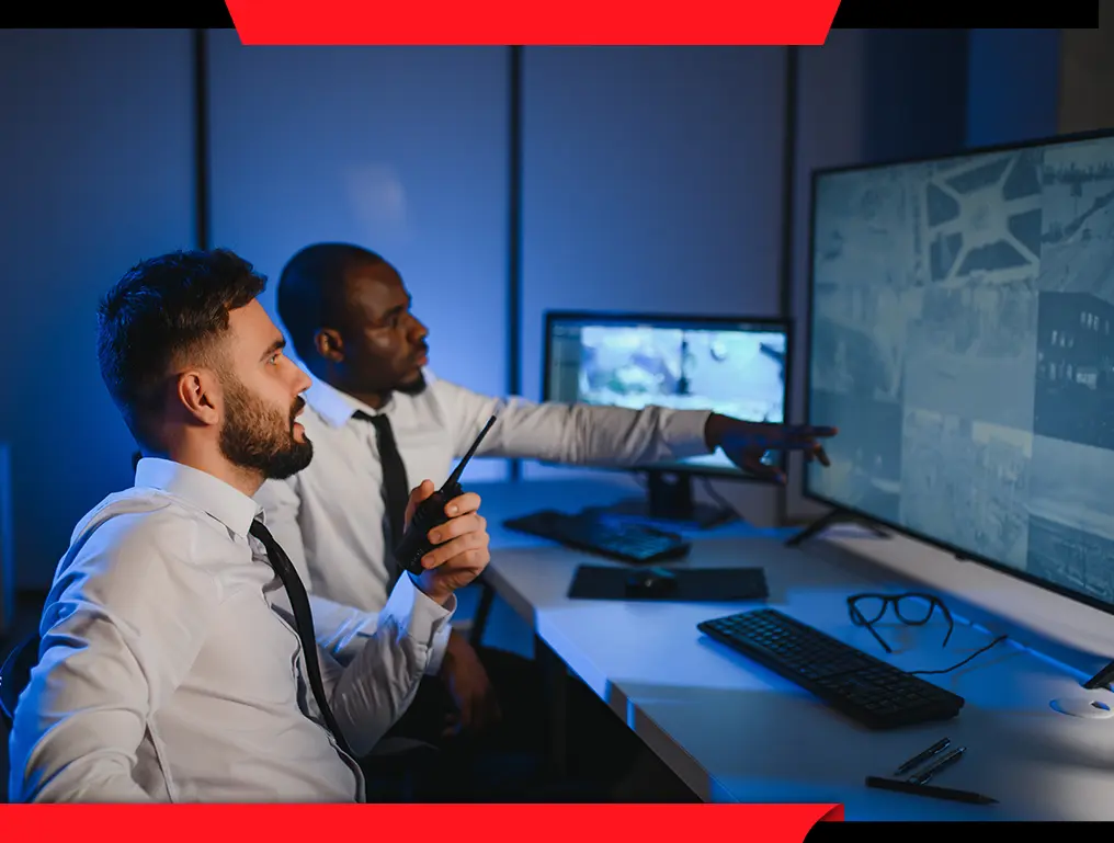 Security officer monitoring video feeds showcasing real-time surveillance by trained officers for enhanced safety