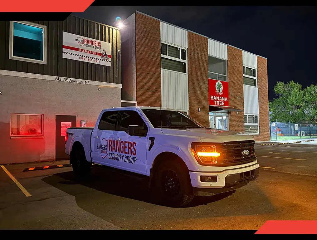 Mobile patrol security guard in uniform, using a wireless device to communicate with the team and providing proactive on-site mobile security services.