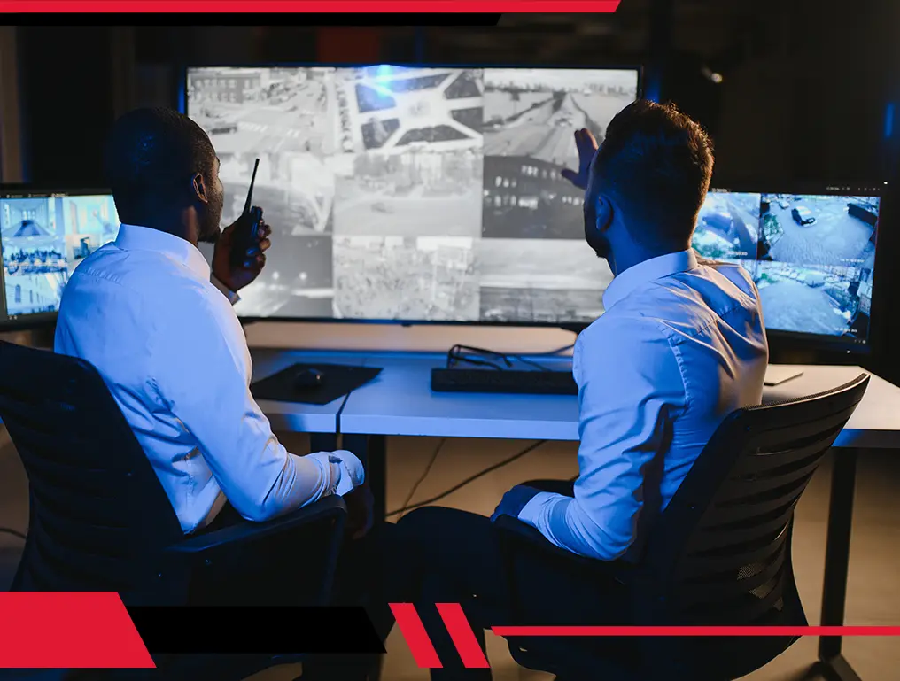 Security officer monitoring video feeds showcasing real-time surveillance by trained officers for enhanced safety