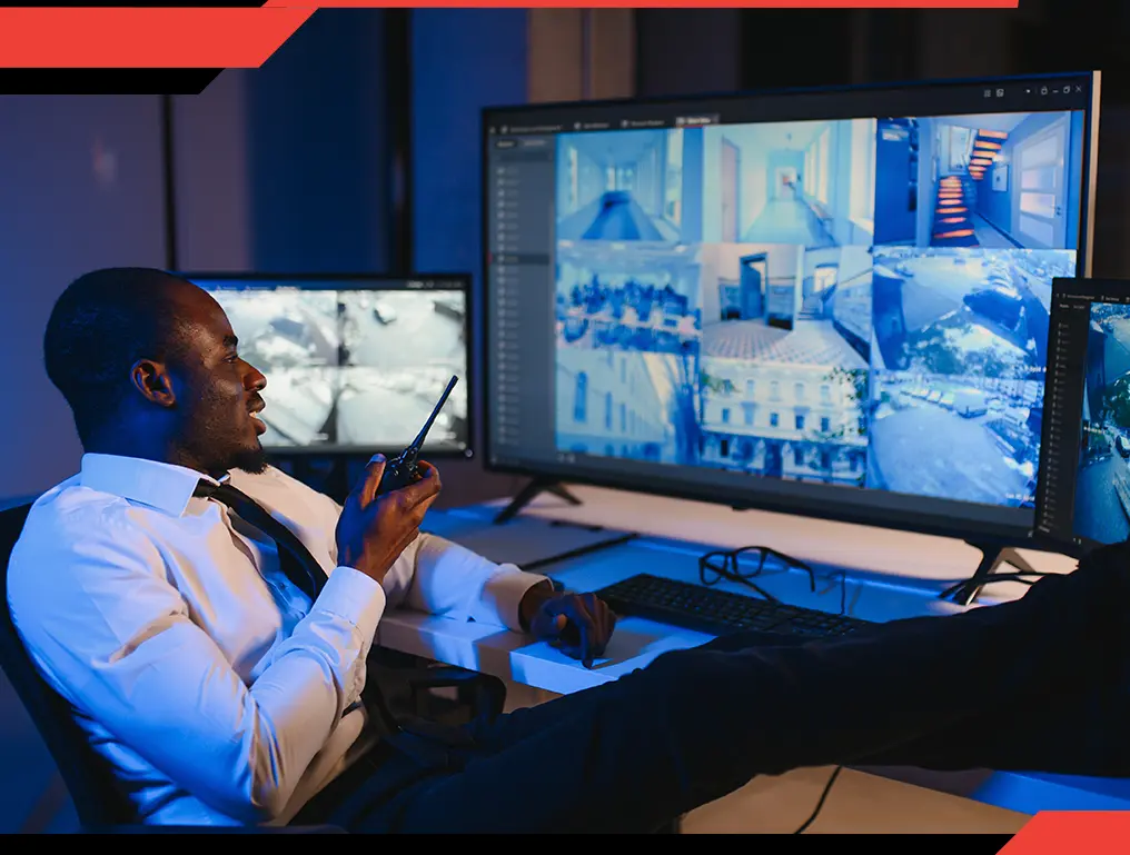 Security officer monitoring video feeds showcasing real-time surveillance by trained officers for enhanced safety